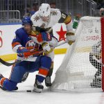 
              New York Islanders' Zach Parise (11) and Vegas Golden Knights' Zach Whitecloud (2) battle for the puck as Vegas goalie Robin Lehner (90) looks on during the second period of an NHL hockey game Sunday, Dec. 19, 2021, in Elmont, N.Y. (AP Photo/John Munson)
            