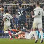 
              Arsenal's Gabriel Martinelli, center, scores his side's second goal during the English Premier League soccer match between Leeds United and Arsenal at Elland Road in Leeds, England, Saturday, Dec. 18, 2021. (AP Photo/Jon Super)
            