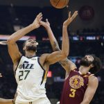 
              Utah Jazz's Rudy Gobert (27) and Cleveland Cavaliers' Ricky Rubio (3) battle for a loose ball in the first half of an NBA basketball game, Sunday, Dec. 5, 2021, in Cleveland. (AP Photo/Tony Dejak)
            