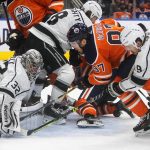 
              Los Angeles Kings goalie Jonathan Quick (32) makes the save on Edmonton Oilers' Connor McDavid (97) as Adrian Kempe (9) defends during the second period of an NHL hockey game in Edmonton, Alberta, Sunday, Dec. 5, 2021. (Jason Franson/The Canadian Press via AP)
            