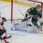 
              Minnesota Wild goaltender Kaapo Kahkonen (34) deflects a puck shot by New Jersey Devils left wing Tomas Tatar (90) with help from Wild defenseman Dmitry Kulikov (29) during the first period of an NHL hockey game, Thursday, Dec. 2, 2021, in St. Paul, Minn. (AP Photo/Andy Clayton-King)
            