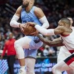 
              Memphis Grizzlies forward Dillon Brooks, left, has the ball tied up by Portland Trail Blazers guard Damian Lillard during the first half of an NBA basketball game in Portland, Ore., Wednesday, Dec. 15, 2021. (AP Photo/Craig Mitchelldyer)
            