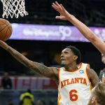 
              Atlanta Hawks guard Lou Williams (6) gets past Orlando Magic center Moritz Wagner, right, for a shot during the first half of an NBA basketball game, Wednesday, Dec. 15, 2021, in Orlando, Fla. (AP Photo/John Raoux)
            