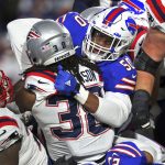
              New England Patriots running back Rhamondre Stevenson (38) is tackled by Buffalo Bills defensive end Greg Rousseau (50) during the second half of an NFL football game in Orchard Park, N.Y., Monday, Dec. 6, 2021. (AP Photo/Joshua Bessex)
            