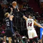 
              Orlando Magic guard Hassani Gravett (12) shoots as Miami Heat guard Tyler Herro (14) defends during the first half of an NBA basketball game, Sunday, Dec. 26, 2021, in Miami. (AP Photo/Lynne Sladky)
            