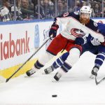 
              Columbus Blue Jackets right wing Jakub Voracek (93) and Toronto Maple Leafs defenceman Justin Holl (3) vie for the puck during the third period of an NHL hockey game Tuesday, Dec. 7, 2021, in Toronto. (Cole Burston/The Canadian Press via AP)
            