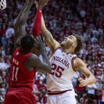 
              Indiana forward Race Thompson (25) battles for a rebound with Nebraska forward Lat Mayen (11) during the second half of a NCAA college basketball game, Saturday, Dec. 4, 2021, in Bloomington, Ind. (AP Photo/Doug McSchooler)
            