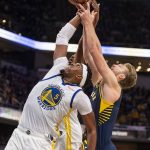 
              Golden State Warriors center Kevon Looney (5) and Indiana Pacers forward Domantas Sabonis (11) battle for a rebound during the second half of an NBA basketball game in Indianapolis, Monday, Dec. 13, 2021. (AP Photo/Doug McSchooler)
            