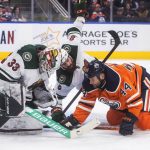 
              Minnesota Wild goalie Cam Talbot (33) makes a save as Edmonton Oilers' Zack Kassian (44) and Jordie Benn (8) work in front of the net during the second period of an NHL hockey game Tuesday, Dec. 7, 2021, in Edmonton, Alberta. (Jason Franson/The Canadian Press via AP)
            