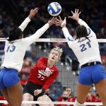 
              Nebraska's Lindsay Krause, center, spikes the ball between Pittsburgh's Leketor Member-Meneh, left, and Serena Gray during a semifinal of the NCAA women's college volleyball tournament Thursday, Dec. 16, 2021, in Columbus, Ohio. (AP Photo/Paul Vernon)
            