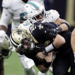 
              New Orleans Saints' Ian Book (16) is sacked by Miami Dolphins' Brandon Jones (29) during the second half of an NFL football game Monday, Dec. 27, 2021, in New Orleans. (AP Photo/Butch Dill)
            