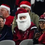 
              Fans dressed as Santa Claus prior to an NFL football game between the Indianapolis Colts and the Arizona Cardinals, Saturday, Dec. 25, 2021, in Phoenix. (AP Photo/Ross D. Franklin)
            