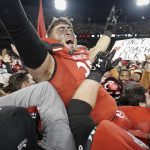 
              Cincinnati's Ryan Royer, center, celebrates with fans after winning the American Athletic Conference championship NCAA college football game against Houston Saturday, Dec. 4, 2021, in Cincinnati. (AP Photo/Jeff Dean)
            