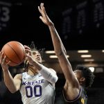 
              Kansas State's Mike McGuirl (00) shoots under pressure from Albany's Paul Newman during the first half of an NCAA college basketball game Wednesday, Dec. 1, 2021, in Manhattan, Kan. (AP Photo/Charlie Riedel)
            