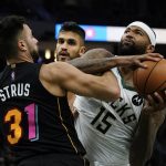 
              Milwaukee Bucks' DeMarcus Cousins is fouled by Miami Heat's Max Strus during the second half of an NBA basketball game Saturday, Dec. 4, 2021, in Milwaukee. (AP Photo/Morry Gash)
            