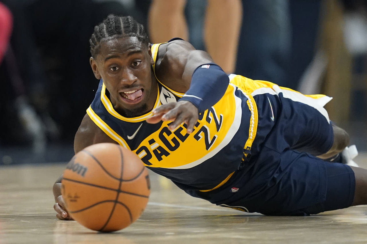 Indiana Pacers' Caris LeVert dives for a looser ball during the first half of an NBA basketball gam...