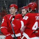 
              Detroit Red Wings center Sam Gagner, center, celebrates his goal against the New York Islanders with center Carter Rowney, left, and right wing Givani Smith (48) during the first period of an NHL hockey game Saturday, Dec. 4, 2021, in Detroit. (AP Photo/Duane Burleson)
            