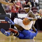 
              Arkansas guard Chris Lykes (11) gets tangled up with Hofstra forward Abayomi Iyiola (35) as they fight for a loose ball during the first half of an NCAA college basketball game, Saturday, Dec. 18, 2021, in Little Rock, Ark. (AP Photo/Michael Woods)
            