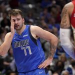 
              Dallas Mavericks guard Luka Doncic (77) looks toward an official standing nearby after being fouled by New Orleans Pelicans' Willy Hernangomez, right, while shooting in the second half of an NBA basketball game in Dallas, Friday, Dec. 3, 2021. (AP Photo/Tony Gutierrez)
            