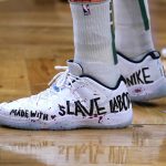 
              Boston Celtics center Enes Kanter Freedom wears basketball shoes bearing his political message during the first half of an NBA basketball game, Wednesday, Dec. 1, 2021, in Boston. The Boston Celtics center changed his name from Enes Kanter to Enes Kanter Freedom in celebration of him officially becoming a United States citizen on Monday. (AP Photo/Charles Krupa)
            