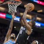 
              Sacramento Kings forward Harrison Barnes (40) scores a basket in front of Los Angeles Clippers guard Paul George, left, during the first quarter of an NBA basketball game in Sacramento, Calif., Wednesday, Dec. 22, 2021. (AP Photo/José luis Villegas)
            