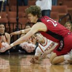 
              Incarnate Word forward Benjamin Griscti (24) and Texas forward Brock Cunningham (30) scramble for a loose ball during the first half of an NCAA college basketball game, Tuesday, Dec. 28, 2021, in Austin, Texas. (AP Photo/Eric Gay)
            