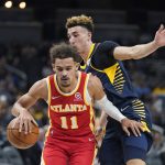 
              Atlanta Hawks' Trae Young (11) is defended by Indiana Pacers' Chris Duarte during the first half of an NBA basketball game Wednesday, Dec. 1, 2021, in Indianapolis. (AP Photo/Darron Cummings)
            