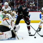 
              Vegas Golden Knights goalie Laurent Brossoit (39) makes a save on a shot by Arizona Coyotes left wing Loui Eriksson (21) as Golden Knights center Mattias Janmark (26) and defenseman Shea Theodore (27) watch during the first period of an NHL hockey game Friday, Dec. 3, 2021, in Glendale, Ariz. (AP Photo/Ross D. Franklin)
            