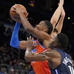 
              Oklahoma City Thunder guard Shai Gilgeous-Alexander, left, goes to the basket in front of Dallas Mavericks forward Dorian Finney-Smith, right, in the second half of an NBA basketball game Sunday, Dec. 12, 2021, in Oklahoma City. (AP Photo/Sue Ogrocki)
            
