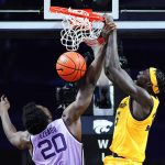 
              Marquette forward Kur Kuath (35) finishes a dunk over Kansas State forward Kaosi Ezeagu (20) during the second half of an NCAA college basketball game Wednesday, Dec. 8, 2021, in Manhattan, Kan. Marquette won 64-63. (AP Photo/Nick Krug)
            