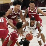 
              Mississippi State guard Iverson Molinar (1) reaches for a loose ball while surrounded by Arkansas players during the second half of an NCAA college basketball game in Starkville, Miss., Wednesday, Dec. 29, 2021. (AP Photo/Rogelio V. Solis)
            