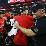 
              Utah coach Kyle Whittingham, right, celebrates with  team after Utah defeated Oregon 38-10 to win the Pac-12 Conference championship NCAA college football game Friday, Dec. 3, 2021, in Las Vegas. (AP Photo/Chase Stevens)
            