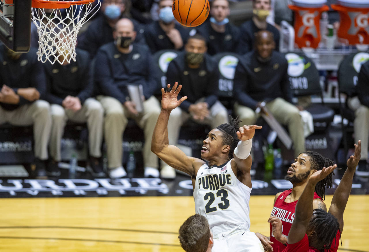 Purdue guard Jaden Ivey (23) watches as his shot heads toward the basket after his drive into the l...