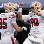 
              San Francisco 49ers tight end George Kittle (85) celebrates with quarterback Jimmy Garoppolo (10) after scoring a touchdown against the Seattle Seahawks during the first half of an NFL football game, Sunday, Dec. 5, 2021, in Seattle. (AP Photo/Elaine Thompson)
            