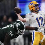 
              Pittsburgh quarterback Nick Patti (12) throws under pressure by Michigan State defensive tackle Dashaun Mallory (94) during the first half of the Peach Bowl NCAA college football game, Thursday, Dec. 30, 2021, in Atlanta. (AP Photo/John Bazemore)
            