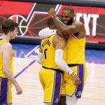 
              Los Angeles Lakers' Austin Reaves (15), Russell Westbrook (0) and LeBron James, right, celebrate after Westbrook scored a 3-point basket during overtime of an NBA basketball game against the Dallas Mavericks in Dallas, Wednesday, Dec. 15, 2021. (AP Photo/Tony Gutierrez)
            