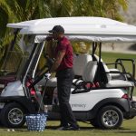 
              Tiger Woods takes a drink during a training session at the Albany Golf Club, in New Providence, Bahamas, Sunday, Dec. 5, 2021.(AP Photo/Fernando Llano)
            