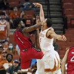 
              Incarnate Word guard RJ Glasper (1) is blocked by Texas forward Dylan Disu (4) during the second half of an NCAA college basketball game, Tuesday, Dec. 28, 2021, in Austin, Texas. (AP Photo/Eric Gay)
            