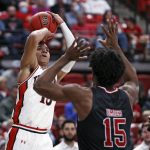
              Texas Tech's Kevin McCullar (15) shoots over Arkansas State's Norchad Omier (15) during the second half of an NCAA college basketball game on Tuesday, Dec. 14, 2021, in Lubbock, Texas. (AP Photo/Brad Tollefson)
            