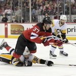 
              New Jersey Devils center Pavel Zacha (37) is tripped by Pittsburgh Penguins defenseman Kris Letang (58) during the second period of an NHL hockey game Sunday, Dec.19, 2021, in Newark, N.J. Letang received a two-minute penalty for the tripping. (AP Photo/Bill Kostroun)
            