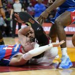 
              Washington Wizards forward Corey Kispert, left, and Miami Heat guard Gabe Vincent go for a loose ball during the first half of an NBA basketball game, Tuesday, Dec. 28, 2021, in Miami. (AP Photo/Lynne Sladky)
            