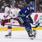 
              Carolina Hurricanes' Brady Skjei (76) avoids a collision with Vancouver Canucks' J.T. Miller (9) during the second period of an NHL hockey game in Vancouver, British Columbia, Sunday, Dec. 12, 2021. (Darryl Dyck/The Canadian Press via AP)
            
