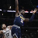 
              Denver Nuggets' Jeff Green (32) goes up for the ball over San Antonio Spurs' Doug McDermott during the first half of an NBA basketball game Thursday, Dec. 9, 2021, in San Antonio. (AP Photo/Darren Abate)
            