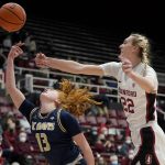 
              Stanford forward Cameron Brink (22) blocks a shot attempt by UC Davis guard Sydney Burns (13) during the first half of an NCAA college basketball game in Stanford, Calif., Wednesday, Dec. 15, 2021. (AP Photo/Jeff Chiu)
            