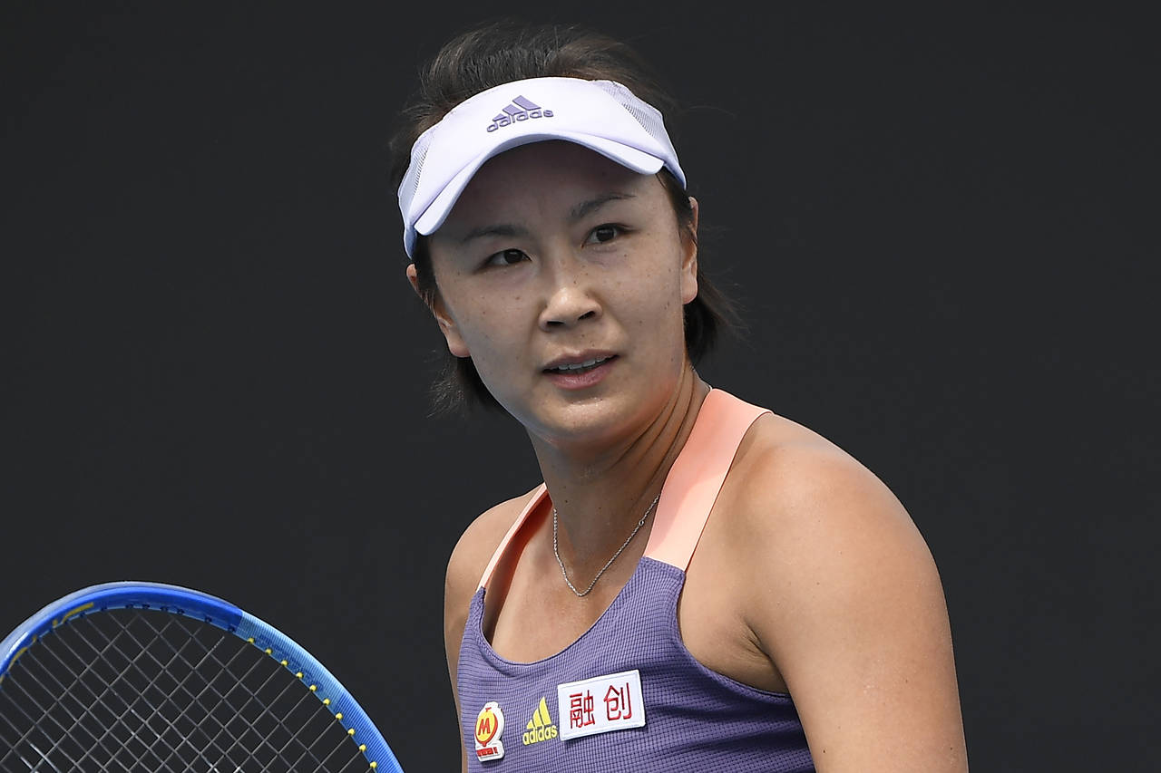 FILE - China's Peng Shuai reacts during her first round singles match against Japan's Nao Hibino at...