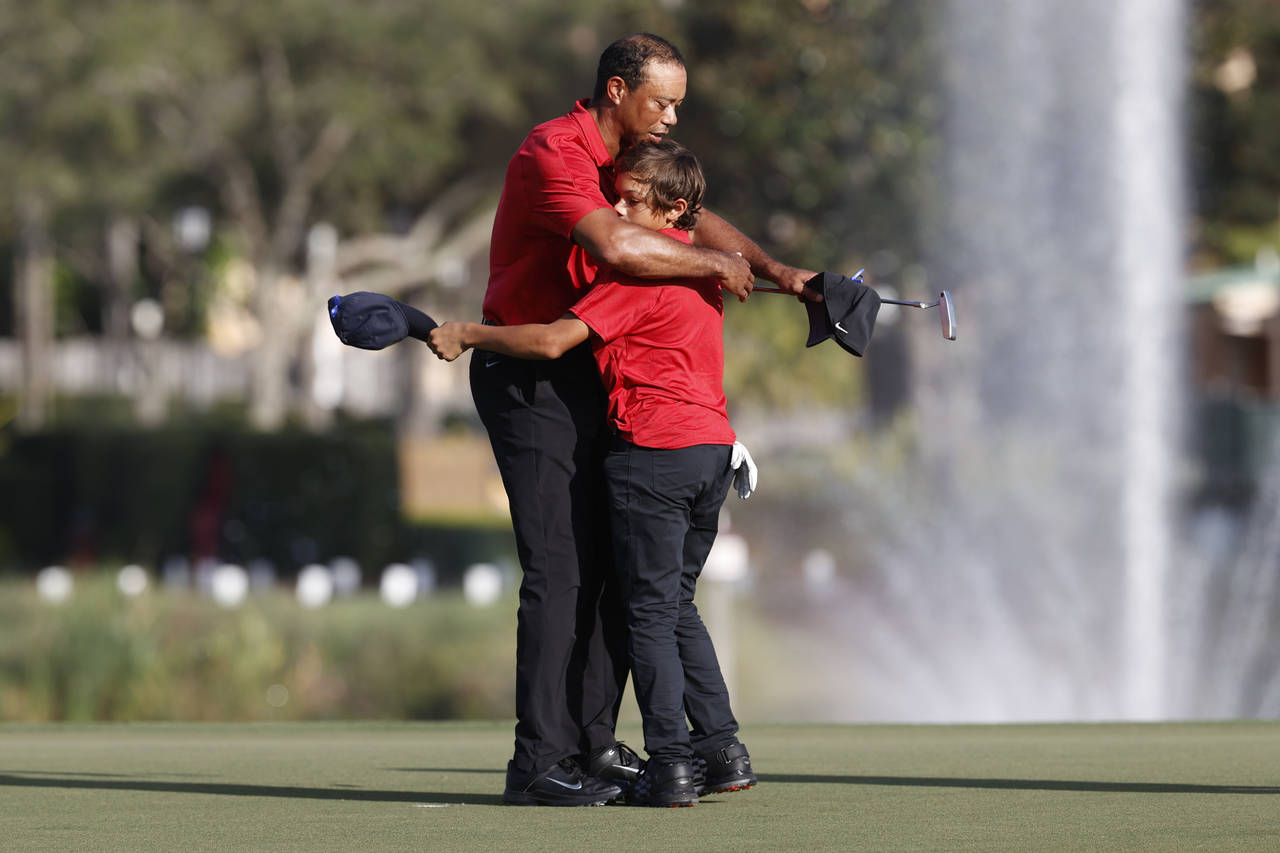 Tiger Woods hugs son Charlie Woods on the 18th green after the second round of the PNC Championship...