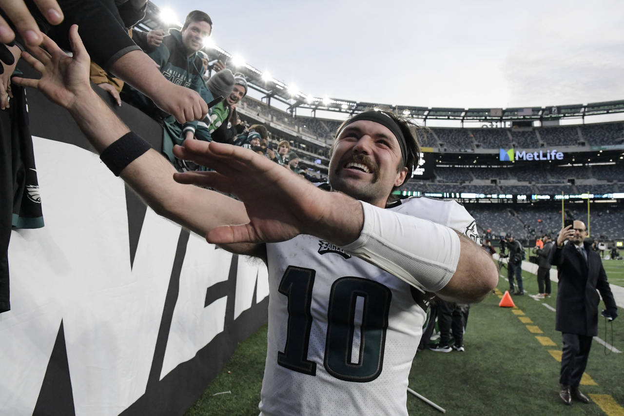 Philadelphia Eagles quarterback Gardner Minshew celebrates with fans after an NFL football game aga...
