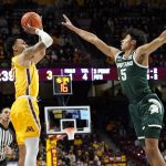 
              Minnesota guard Payton Willis, left, shoots over Michigan State guard Max Christie during the first half an NCAA college basketball game Wednesday, Dec. 8, 2021, in Minneapolis. (AP Photo/Craig Lassig)
            