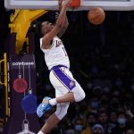 
              Los Angeles Lakers guard Malik Monk (11) dunks during the first half of an NBA basketball game against the Brooklyn Nets in Los Angeles, Saturday, Dec. 25, 2021. (AP Photo/Ashley Landis)
            