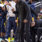 
              Indiana Pacers assistant coach Lloyd Pierce reacts to a call on the court during the second half of an NBA basketball game against the Golden State Warriors in Indianapolis, Monday, Dec. 13, 2021. (AP Photo/Doug McSchooler)
            